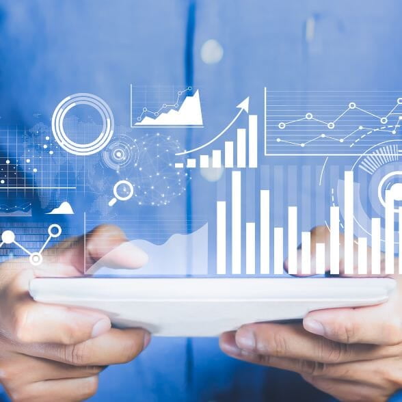 Data Analytics in form of charts on top of a held tablet.